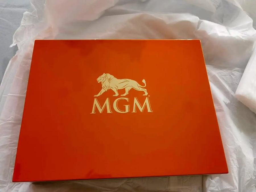 Custom wooden presentation box lid engraved with the MGM logo